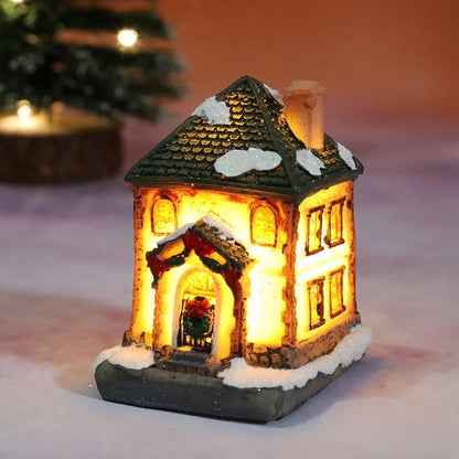 Decorative lit house with snow on the roof, surrounded by a warm glow.